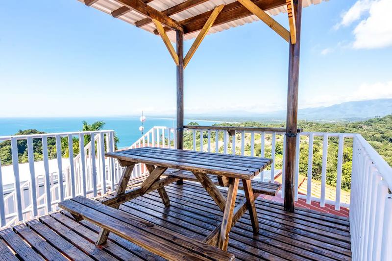 Rooftop picnic table with sweeping views of the ocean and mountains at Casa Alta Vista