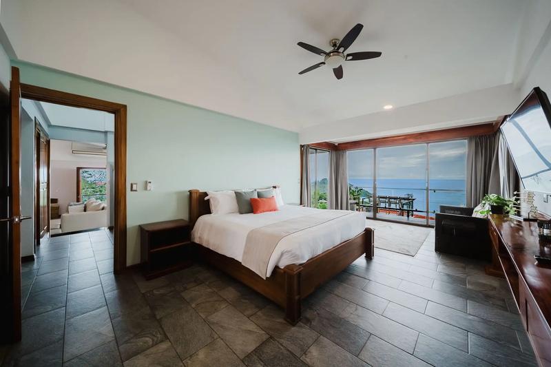 Master bedroom at Casa Grande Vista with glass doors to an ocean view terrace