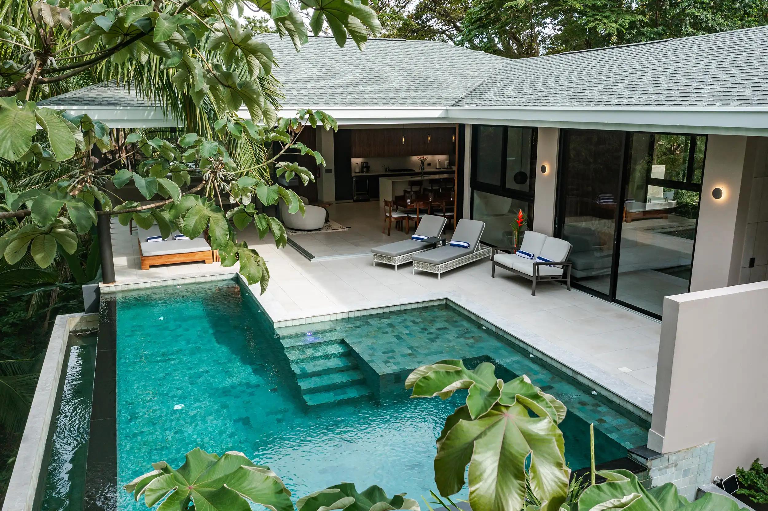 Casa Blue Marlin's L-shaped pool and terrace tucked into the rainforest