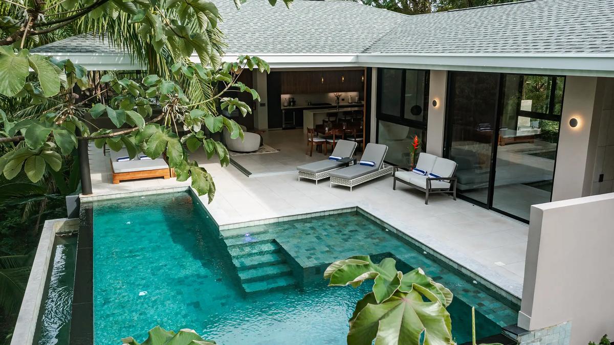 Casa Blue Marlin's L-shaped pool and terrace tucked into the rainforest