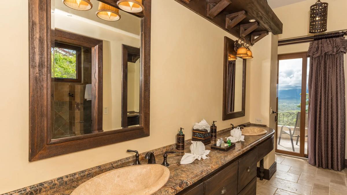 Double vanity with stone sinks and balcony access in a Villa Marbella bathroom