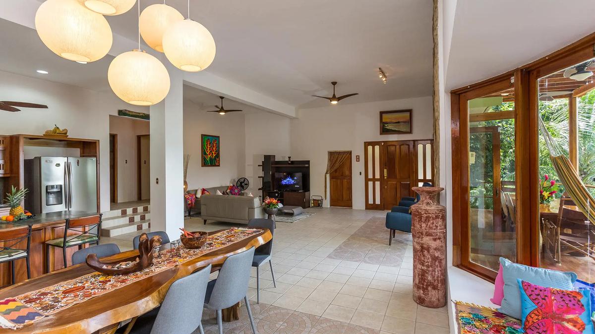Kitchen at Casa Pura Paz with dining table in front and living room beyond