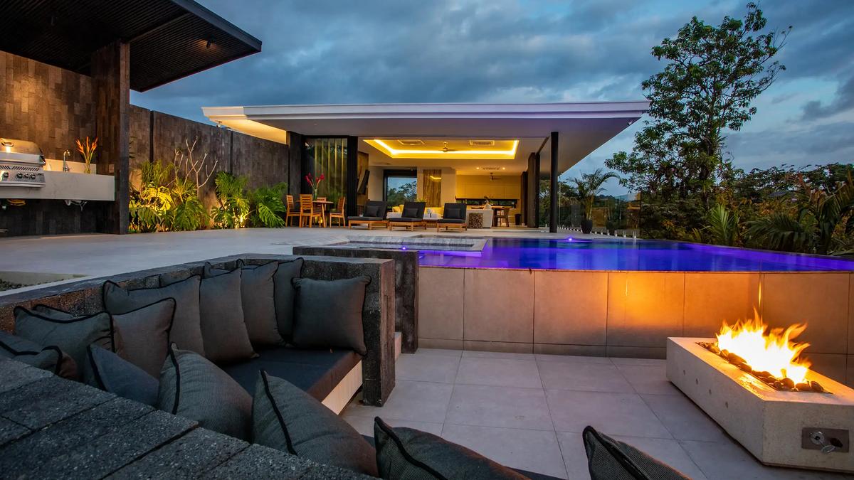 Sunken lounge and fire pit beside the glowing infinity pool at Casa Nueva Vida