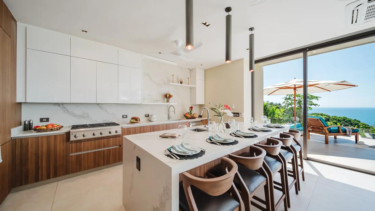 Casa Nola kitchen with marble island seating for six and ocean view terrace beyond