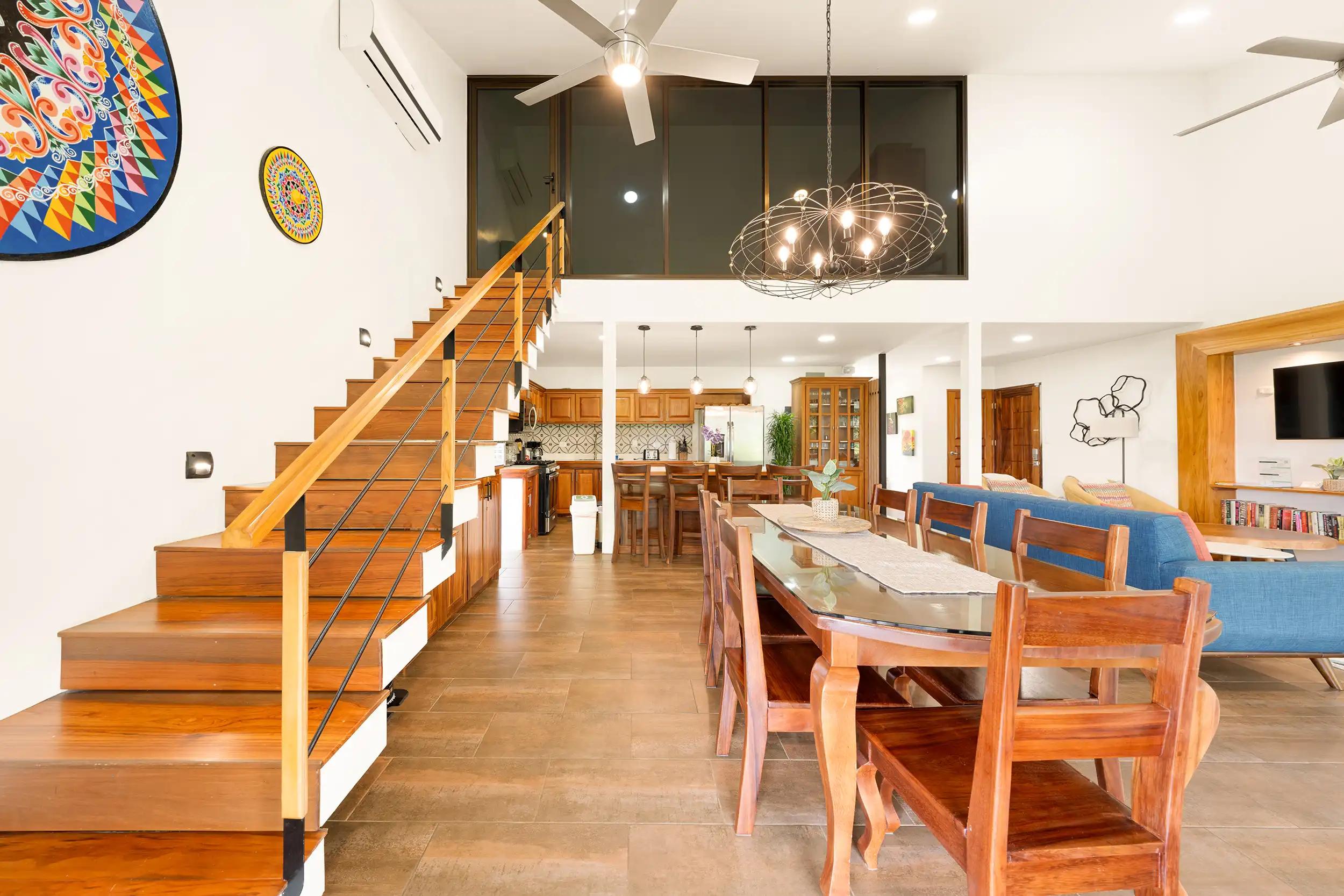 Dining area of Casa Vista Verde beneath the glass walled loft windows