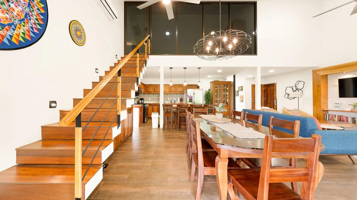Dining area of Casa Vista Verde beneath the glass walled loft windows