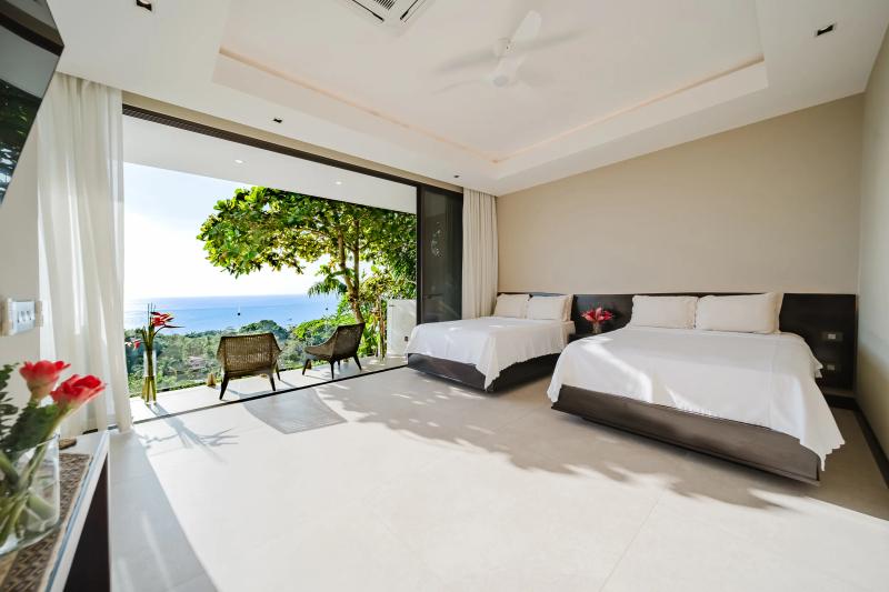 Casa Nola bedroom with twin beds opening straight onto the jungle terrace