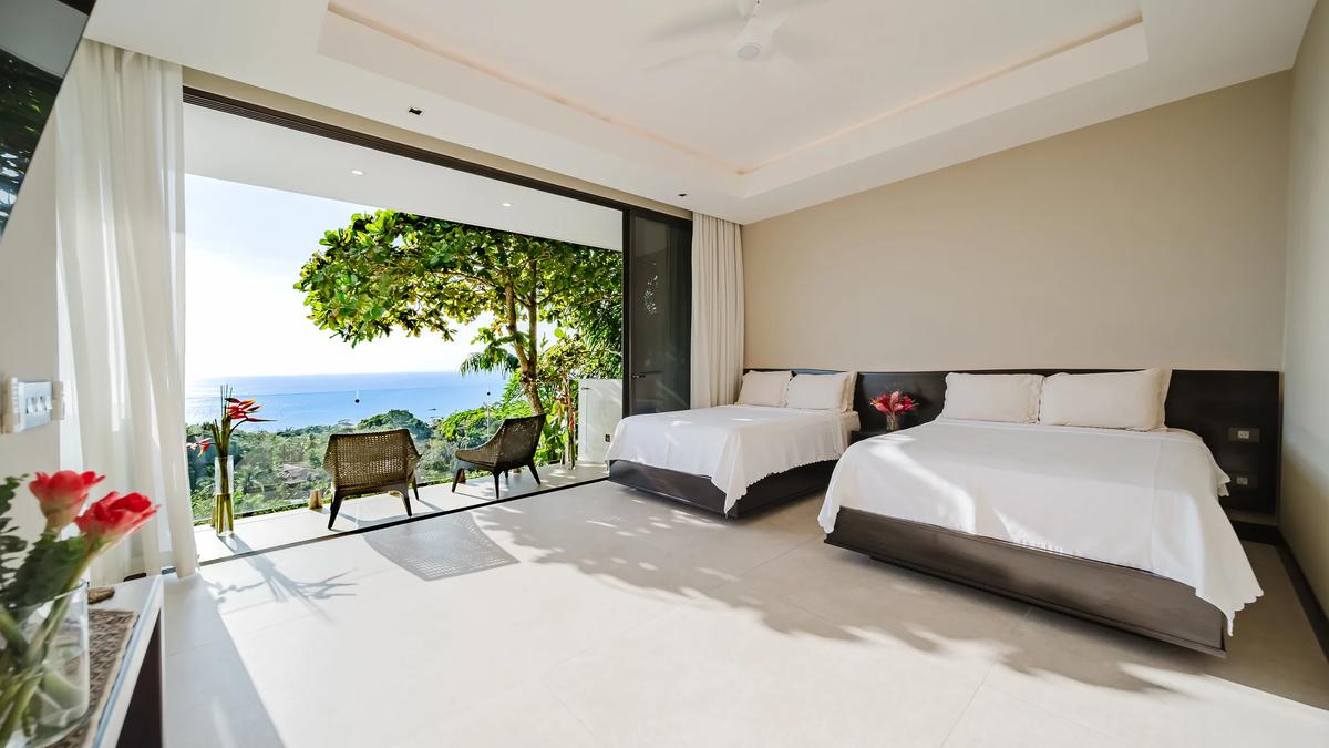 Casa Nola bedroom with twin beds opening straight onto the jungle terrace