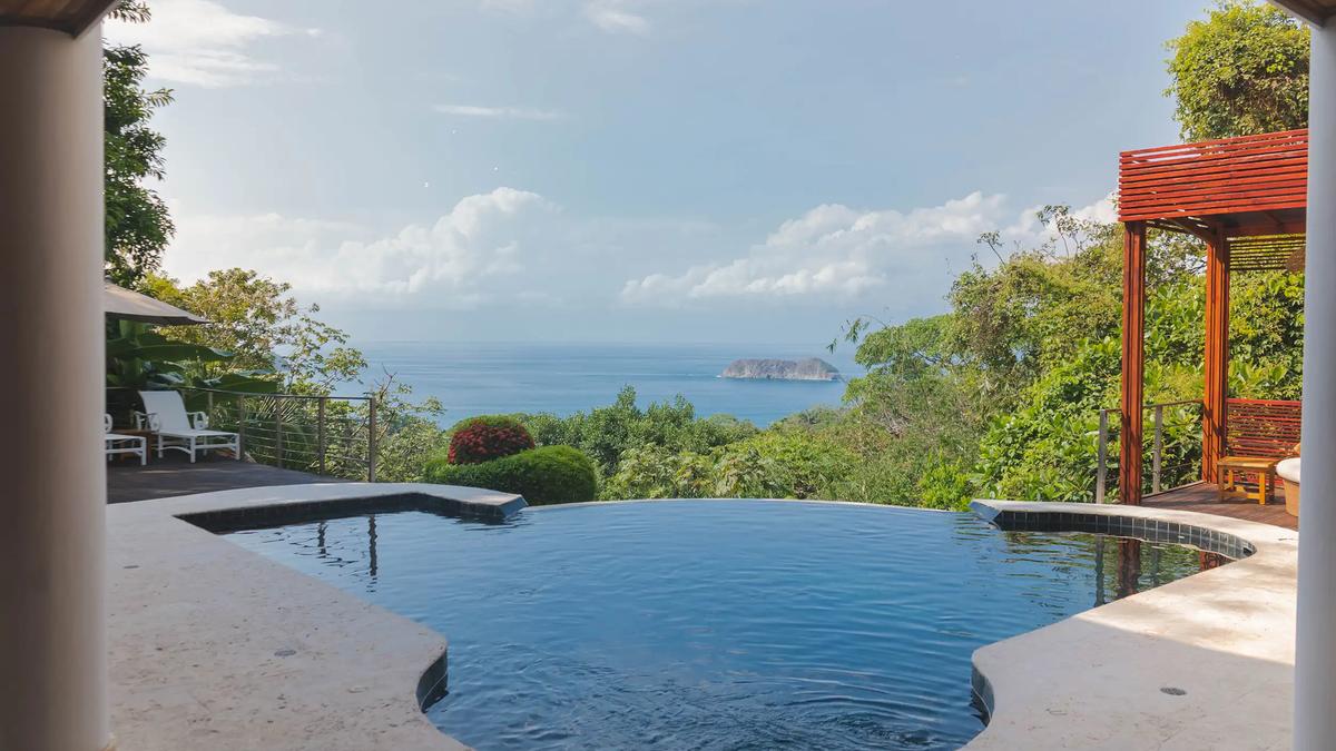 Infinity pool at Casa Anjali overlooking the ocean and a small island