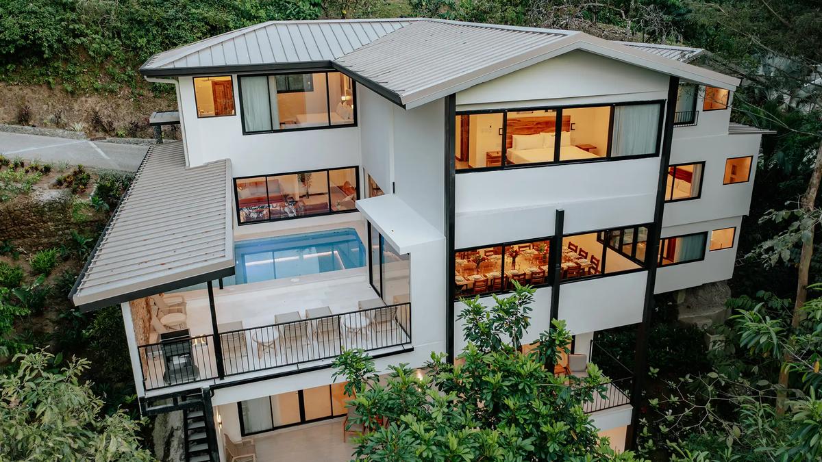 Aerial view of the three story Casa Dos Cascadas villa at twilight