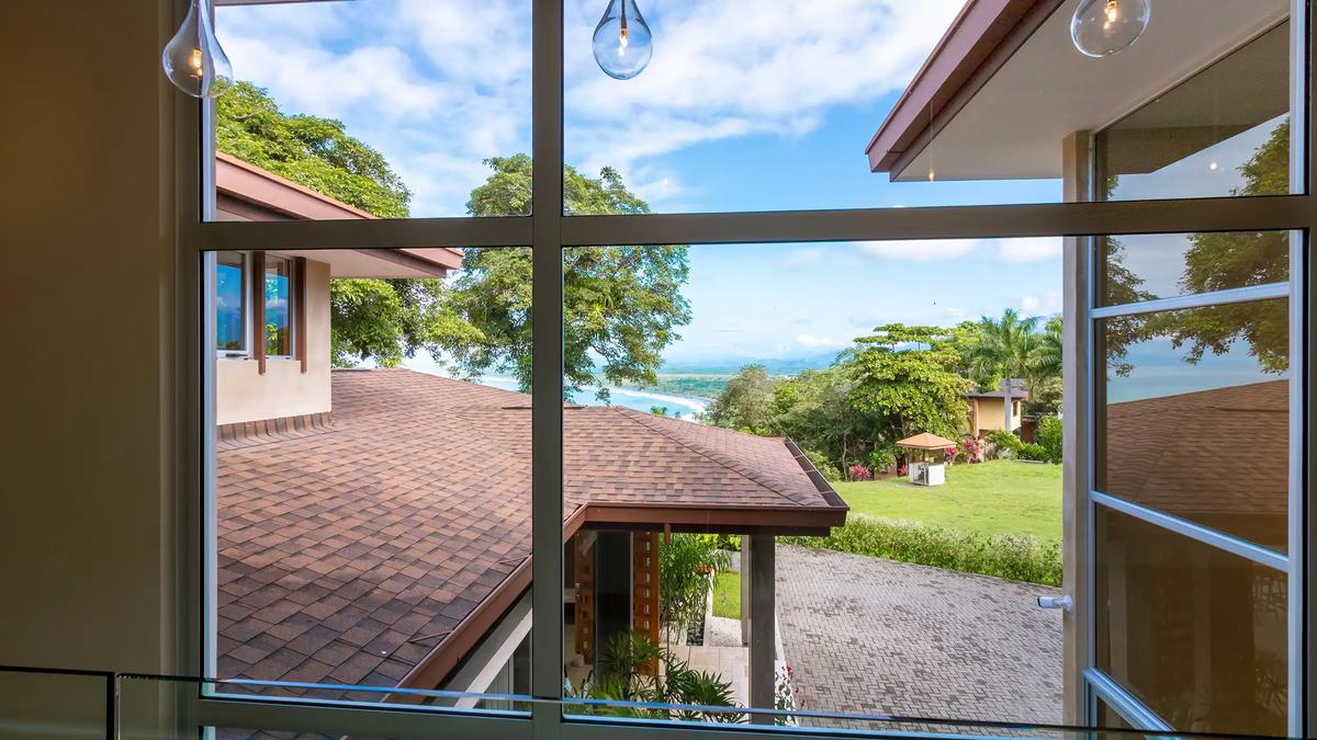 Ocean and coastline view through the upstairs hallway windows at Casa Contee