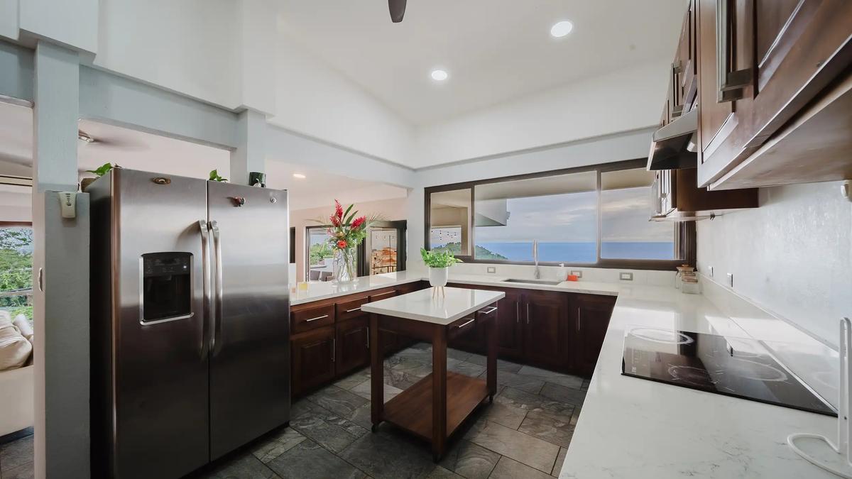 Kitchen at Casa Grande Vista with island cart, quartz counters and ocean view