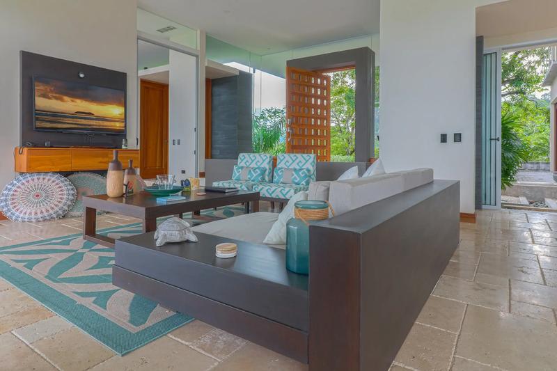 Casa Contee living room with sectional sofa, TV, and turquoise accents
