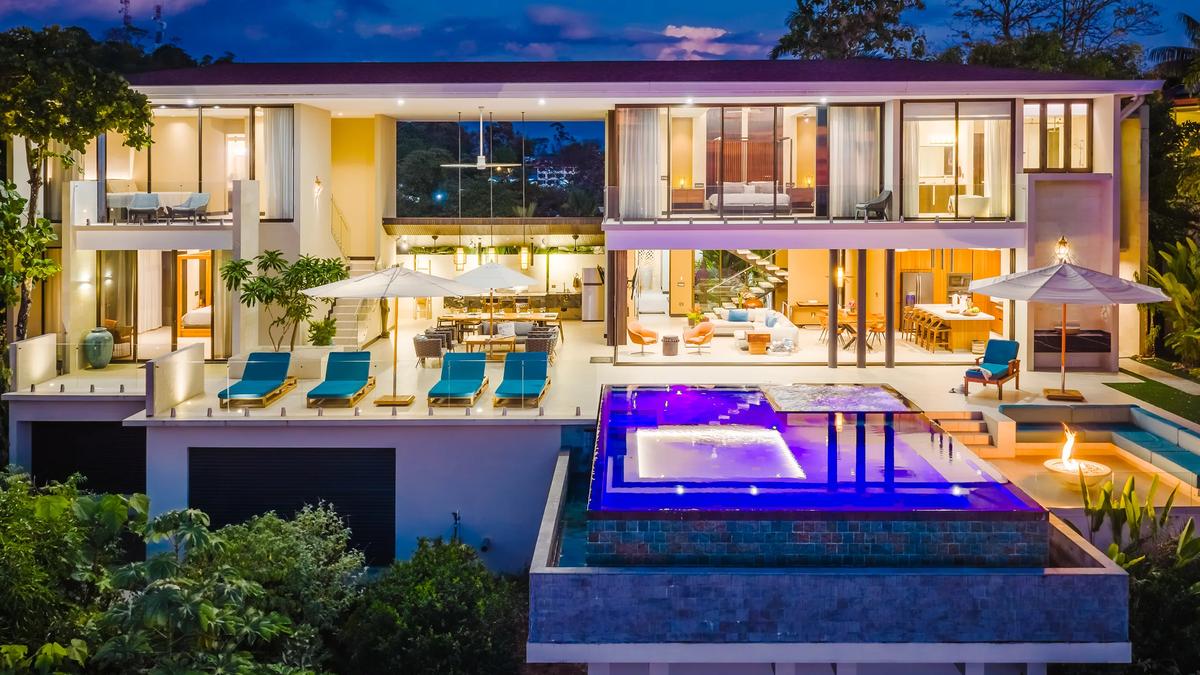 Evening view of Casa Nola's two floors of terraces above the infinity pool