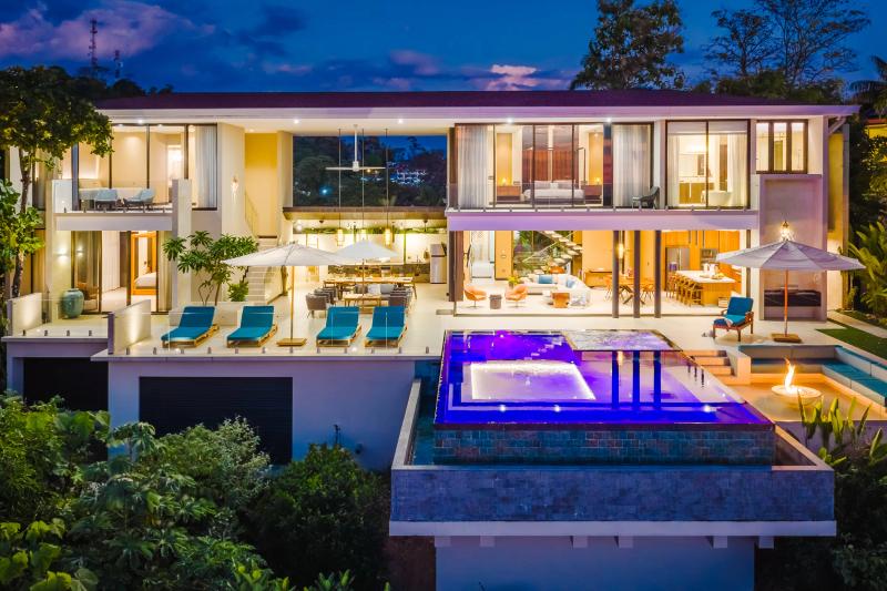 Evening view of Casa Nola's two floors of terraces above the infinity pool