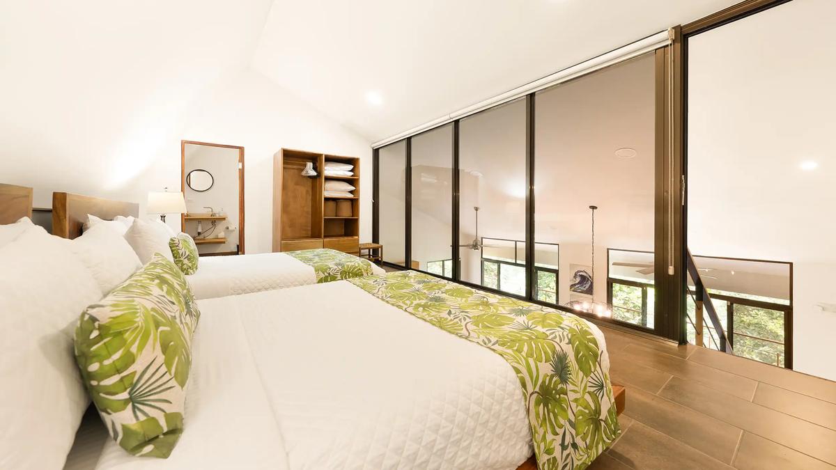 Casa Vista Verde loft bedroom with shades raised above the open living area