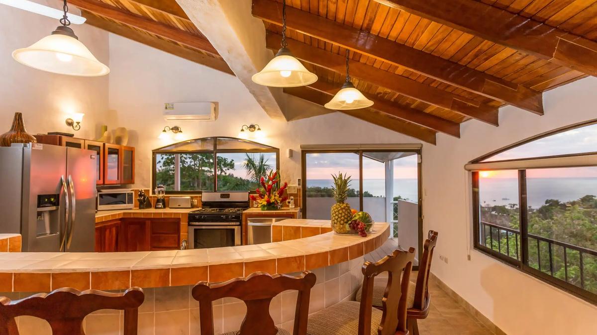 Breakfast bar with pineapple at Casa Moreno as the sun sets over the Pacific