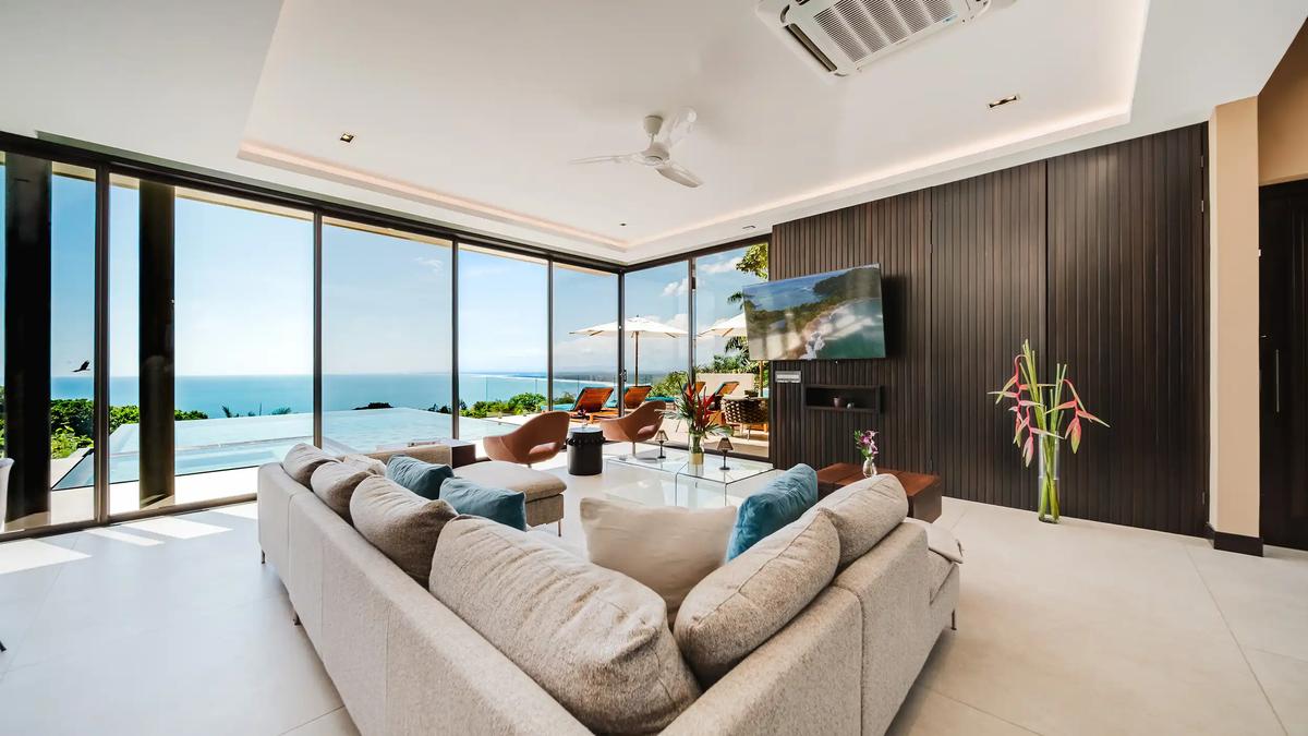 Lounge seating at Casa Nola facing a wood slat media wall beside the infinity pool
