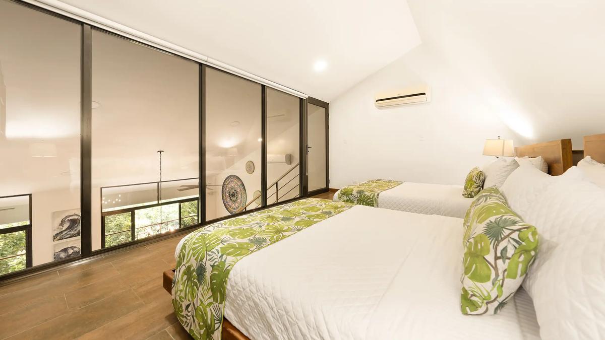 Loft bedroom at Casa Vista Verde overlooking the great room through interior glass