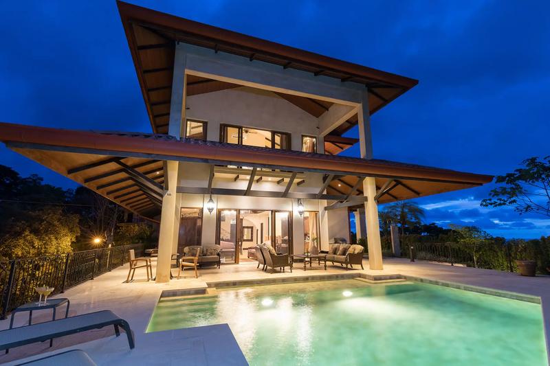 Evening view of Villa Marbella terraces and pool under a deep blue sky