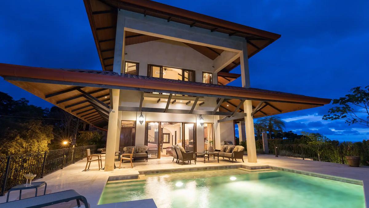 Evening view of Villa Marbella terraces and pool under a deep blue sky