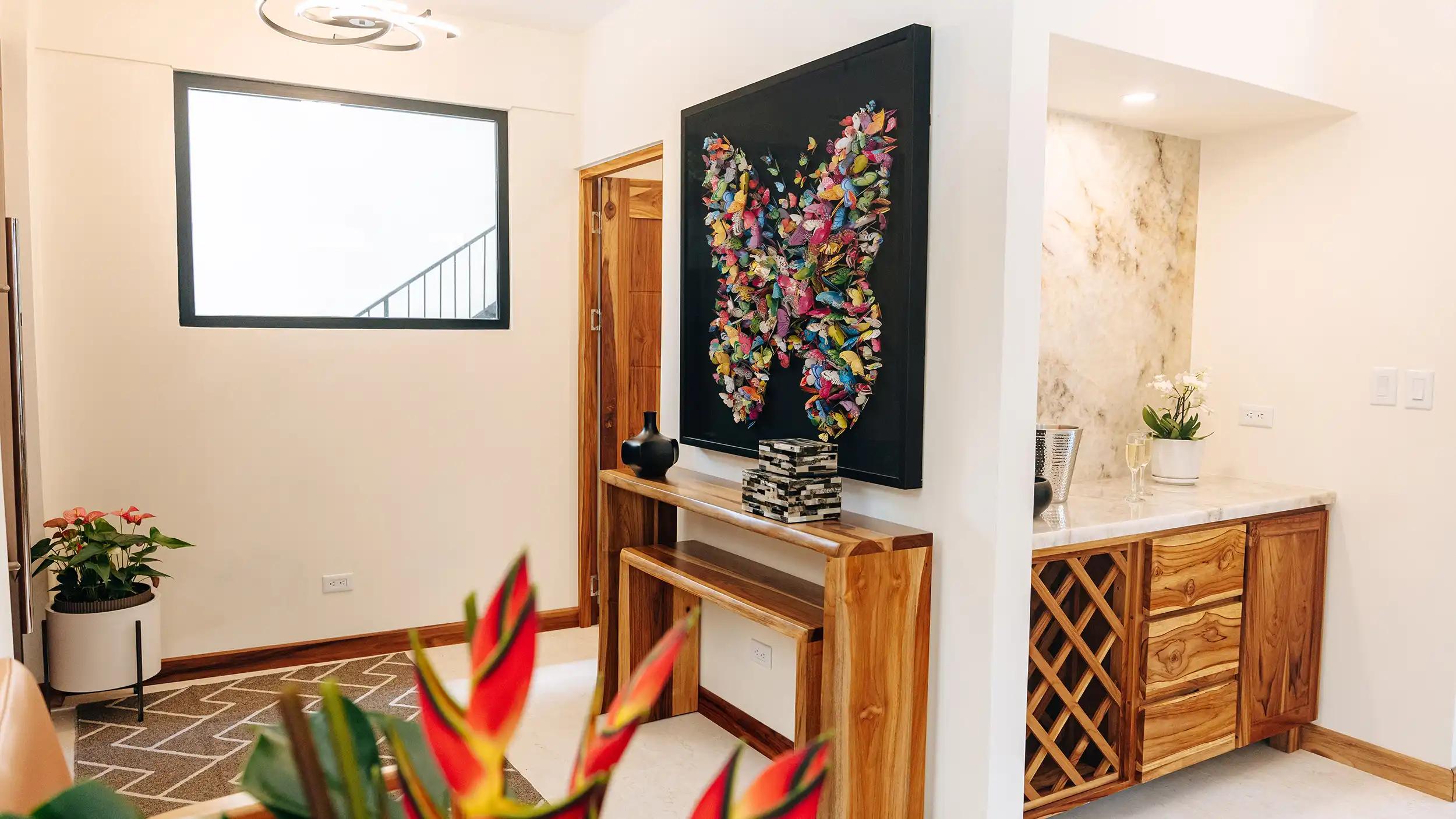 Entry foyer at Casa Dos Cascadas with butterfly artwork and marble wet bar
