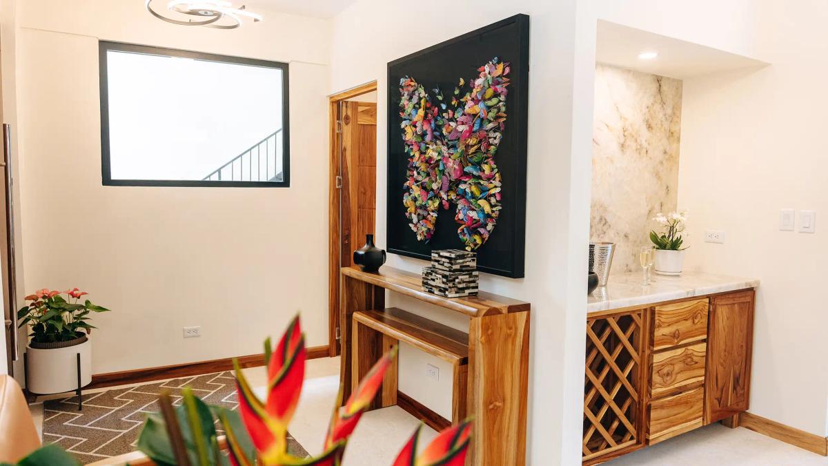 Entry foyer at Casa Dos Cascadas with butterfly artwork and marble wet bar