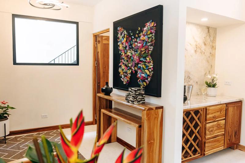 Entry foyer at Casa Dos Cascadas with butterfly artwork and marble wet bar