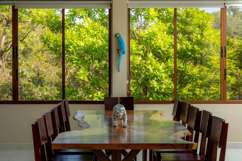 Live edge dining table at Casa Mariposa with jaguar sculpture and jungle views