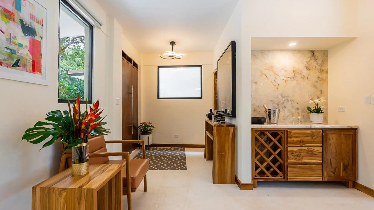 Casa Dos Cascadas entry hall with leather chairs, console table, and wet bar