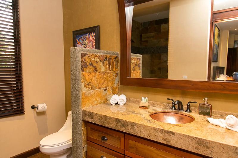 Bathroom vanity with hammered copper sink and granite countertop at Casa Anaka