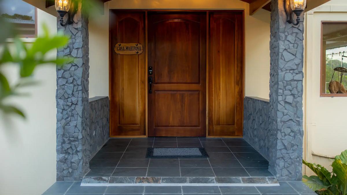 Wooden double front door and stone pillars at the Casa Mariposa entrance