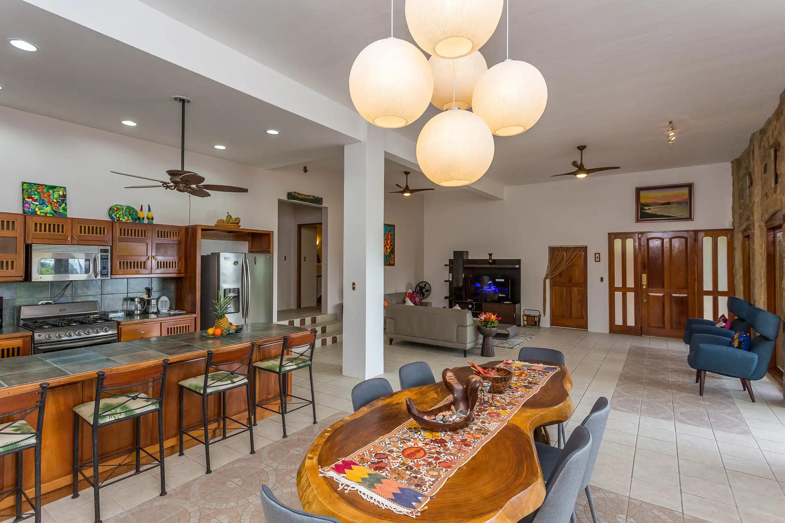 Kitchen at Casa Pura Paz with dining table in front and living room beyond