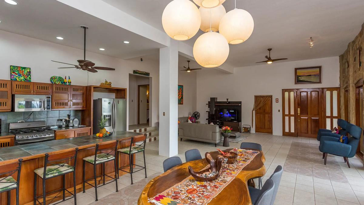 Kitchen at Casa Pura Paz with dining table in front and living room beyond