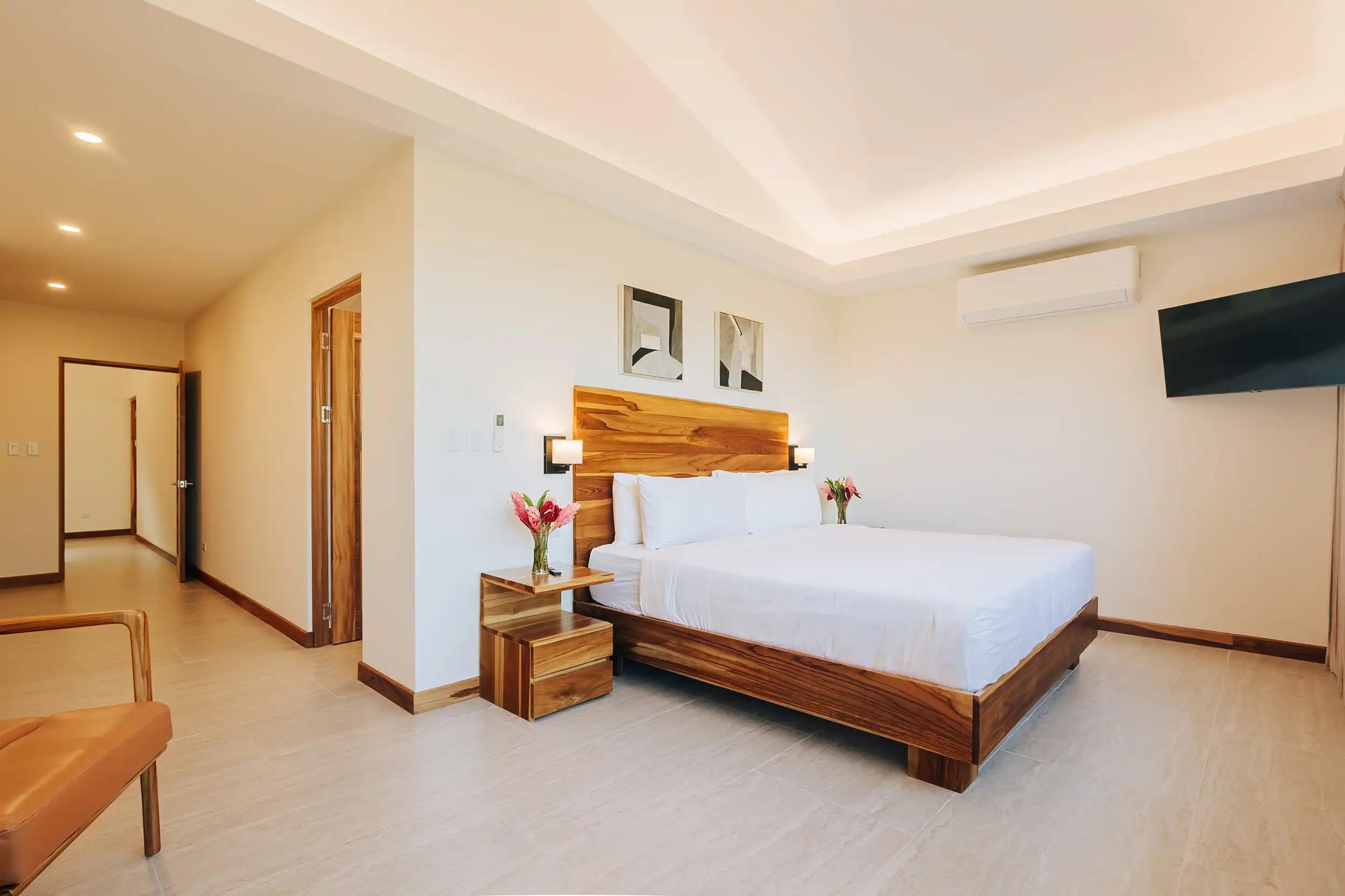 Spacious king suite at Casa Dos Cascadas with cove lighting and sitting area