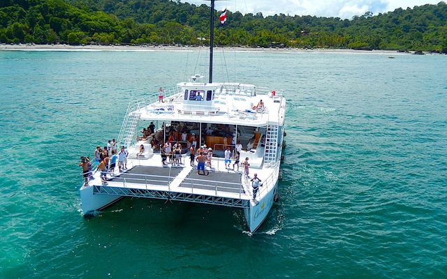 Catamaran sailing off the Manuel Antonio coast at sunset