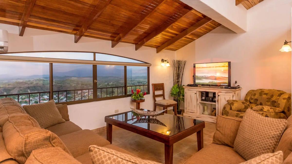 Casa Moreno lounge at dusk with valley views and warm wall lighting