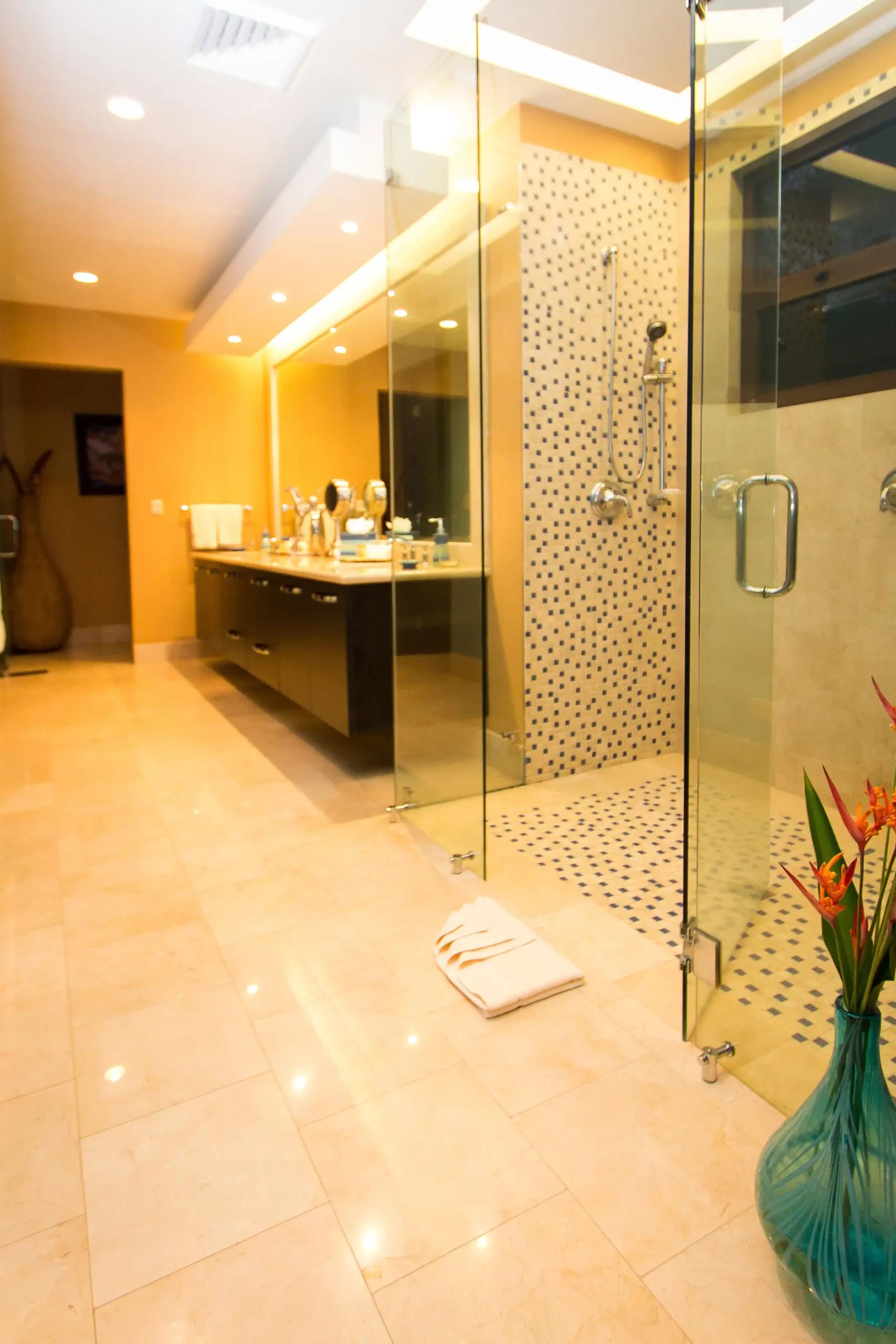 Walk-in mosaic tile shower and floating double vanity in a Villa Celaje bathroom