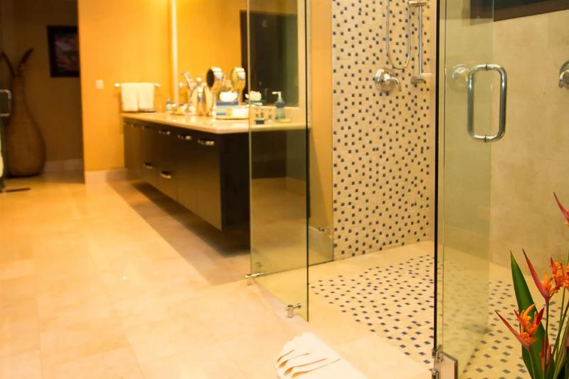 Walk-in mosaic tile shower and floating double vanity in a Villa Celaje bathroom