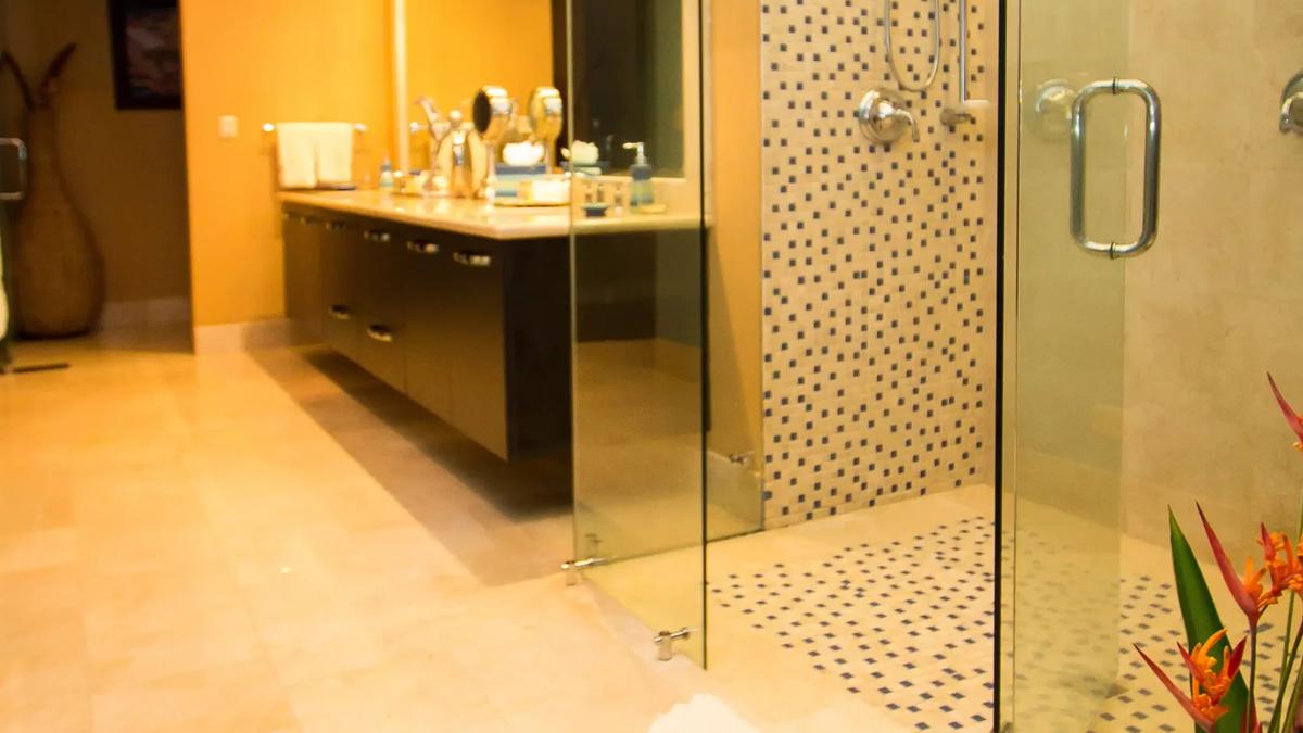 Walk-in mosaic tile shower and floating double vanity in a Villa Celaje bathroom