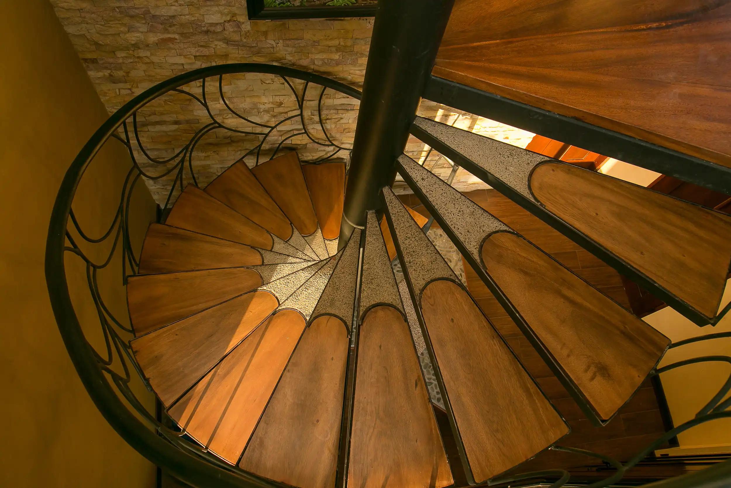 Looking down the wooden treads of the spiral staircase at Casa Anaka
