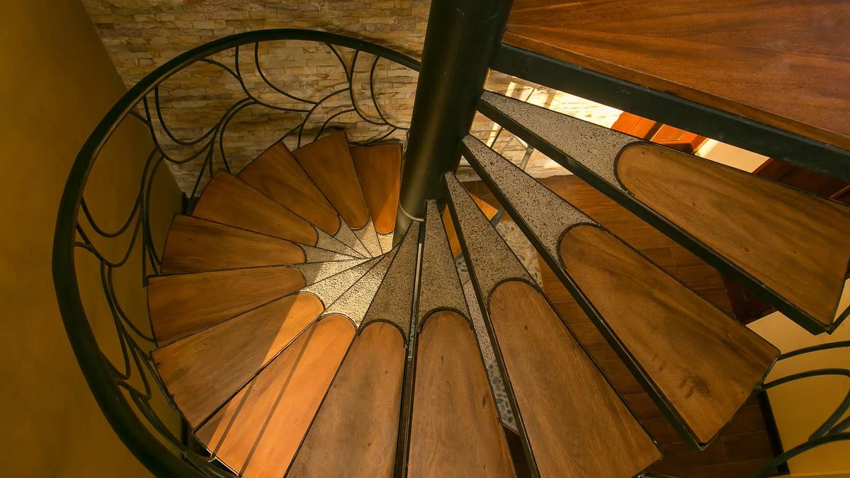 Looking down the wooden treads of the spiral staircase at Casa Anaka