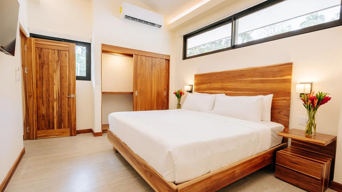 Bright bedroom with clerestory windows and teak closet at Casa Dos Cascadas