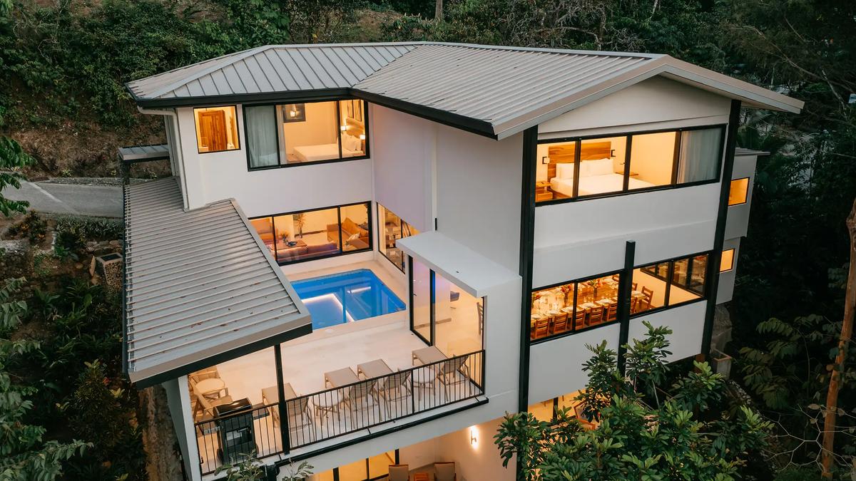 Evening aerial of Casa Dos Cascadas showing pool, balcony, and dining room