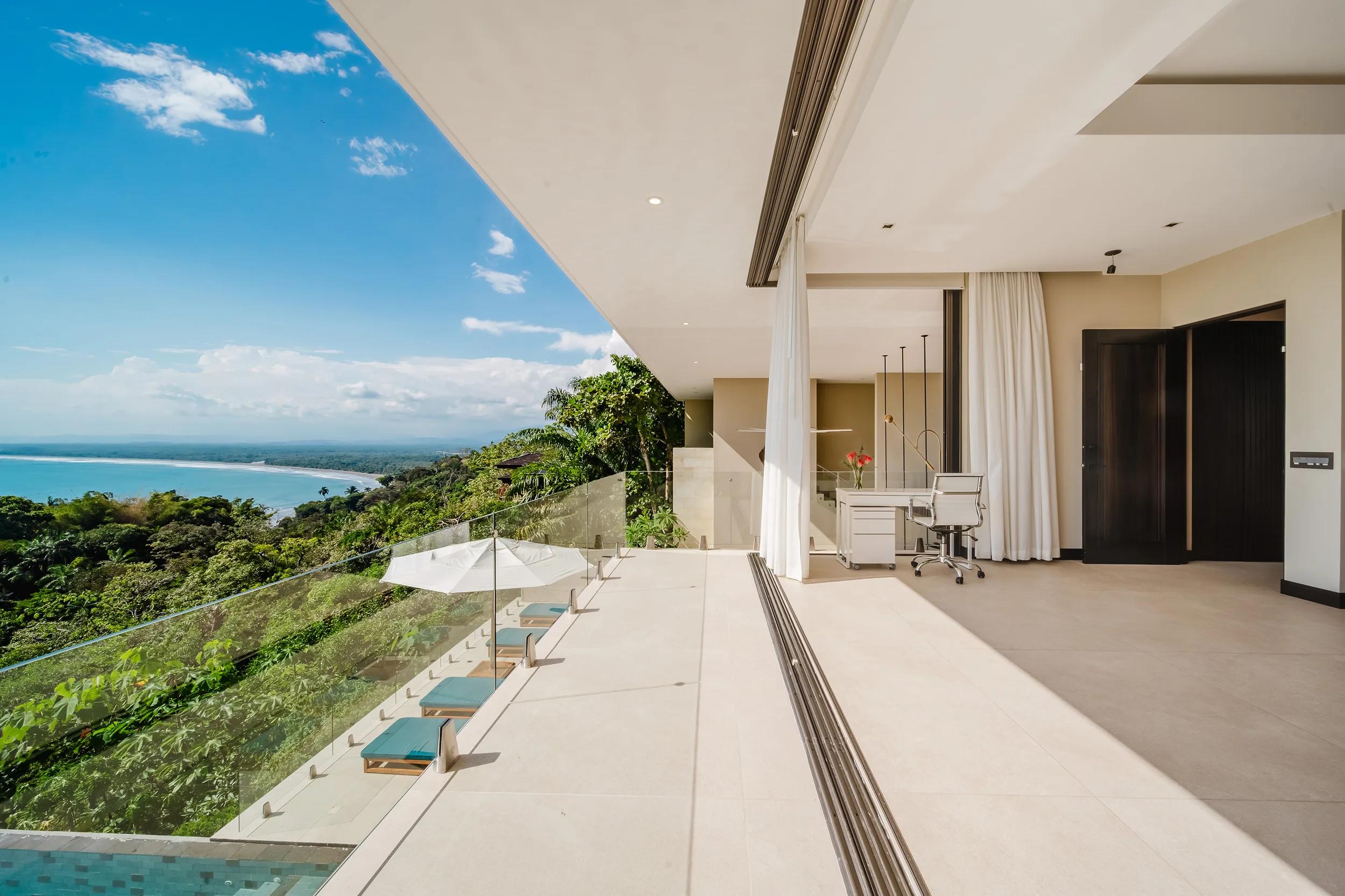 Bedroom terrace at Casa Nola with a daybed and a view over the rainforest to the sea