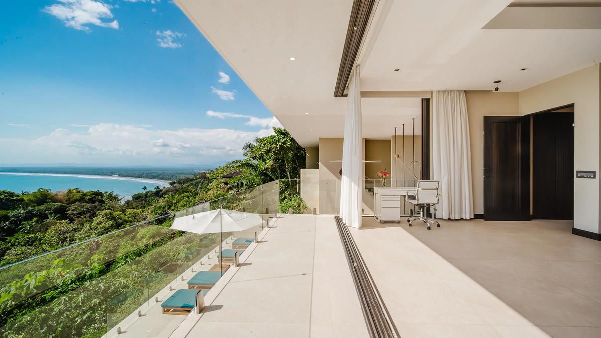 Bedroom terrace at Casa Nola with a daybed and a view over the rainforest to the sea