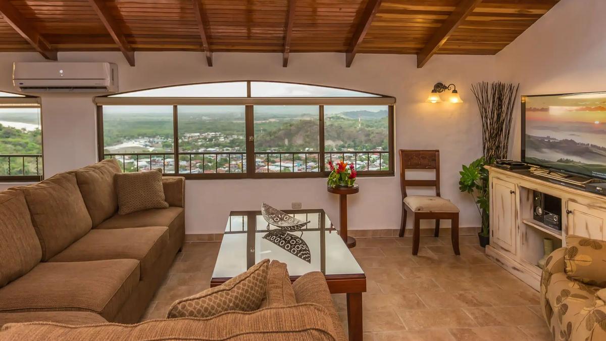 Casa Moreno living room with arched picture window overlooking Quepos