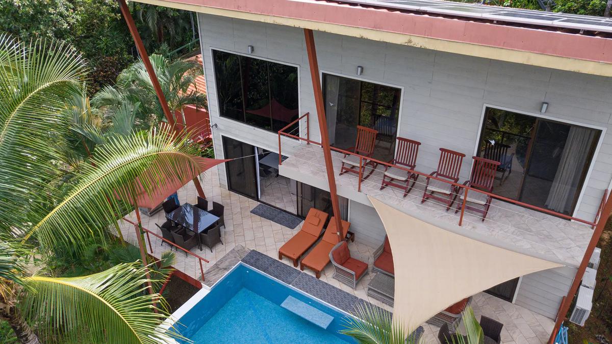Drone view of the two story Casa Serenidad with plunge pool and shade sails