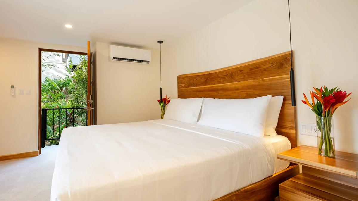 King bedroom at Casa Dos Cascadas with open door to the garden balcony