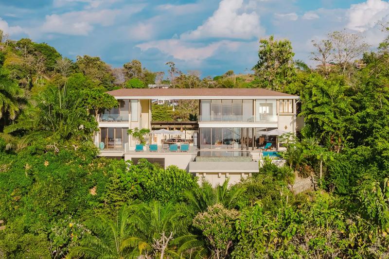 Aerial view of Casa Nola, a modern two story villa framed by rainforest canopy